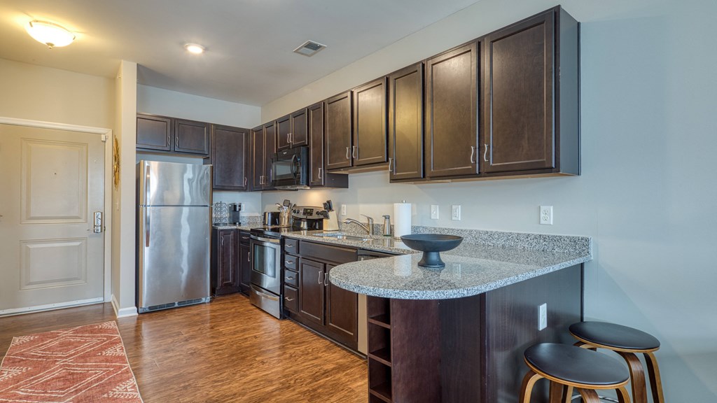 a kitchen with stainless steel appliances and a granite counter top