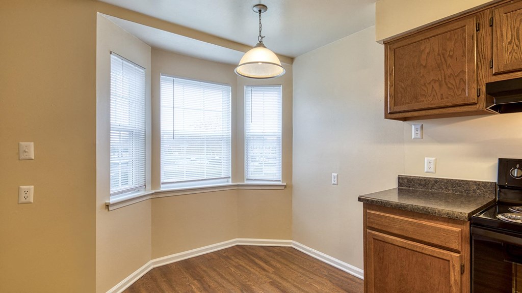 A kitchen with wooden cabinets and a countertop.