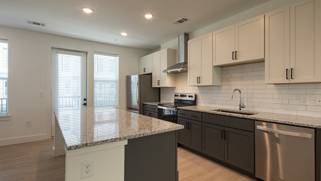 a kitchen with white cabinets and a granite counter top at Ainsworth, Richmond, 23228