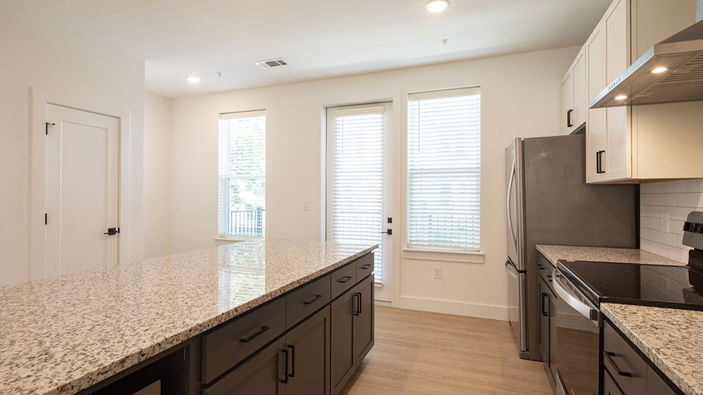 a kitchen with white walls and a granite counter top at Ainsworth, Richmond