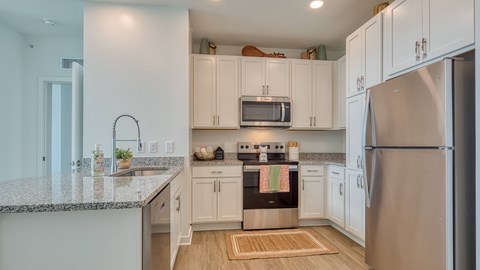 a kitchen with white cabinets and stainless steel appliances at Allure at Edinburgh, Chesapeake, VA, 23322