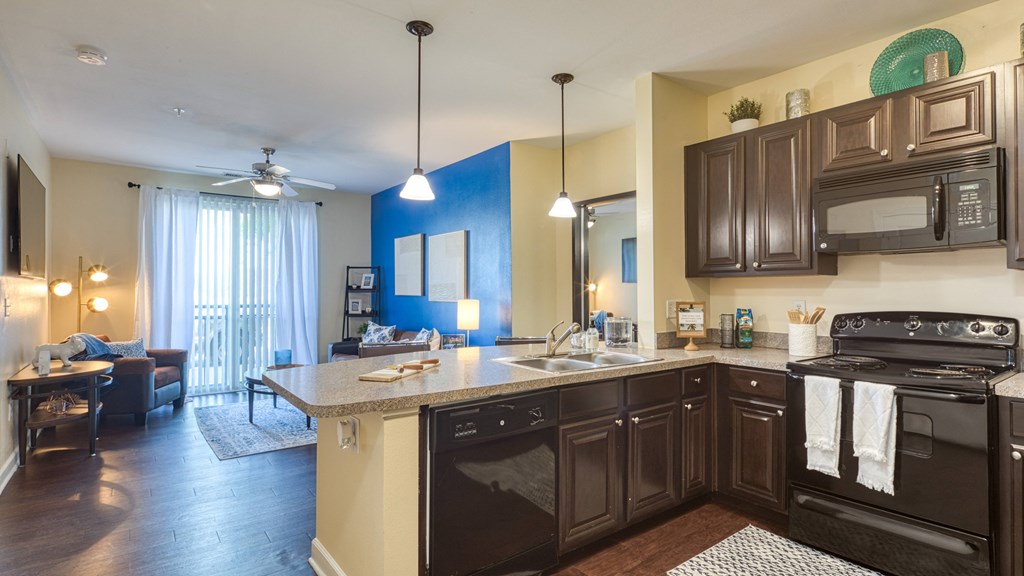 a kitchen with black appliances and a counter top at Proximity at ODU, Norfolk