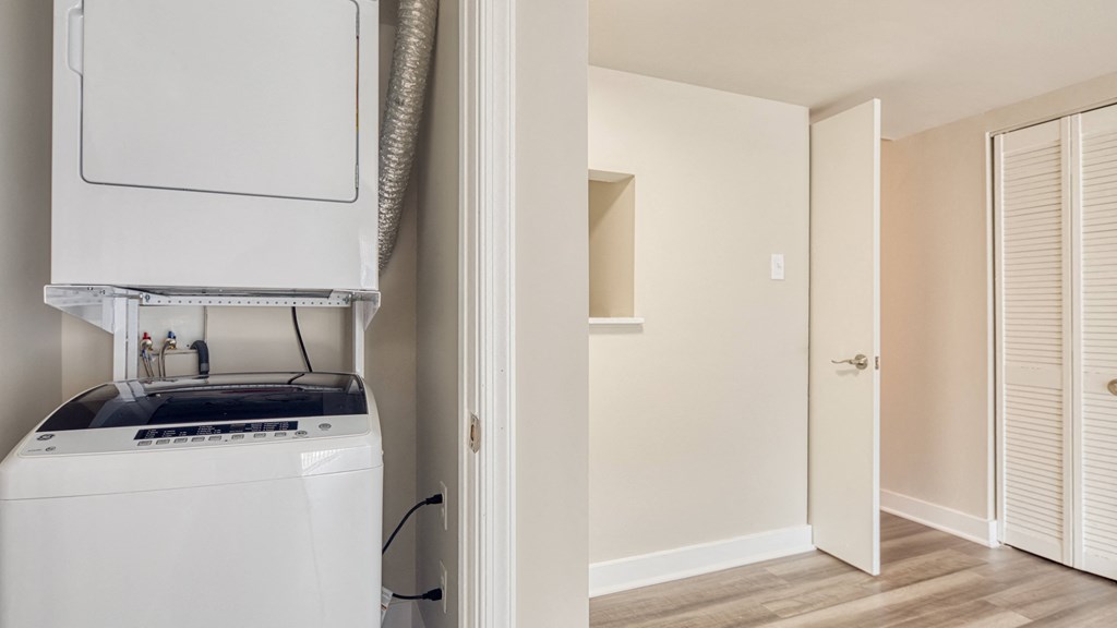 a kitchen with a stove and a refrigerator and a closet