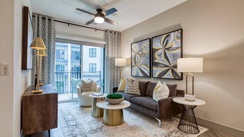 a living room with a couch and a ceiling fan