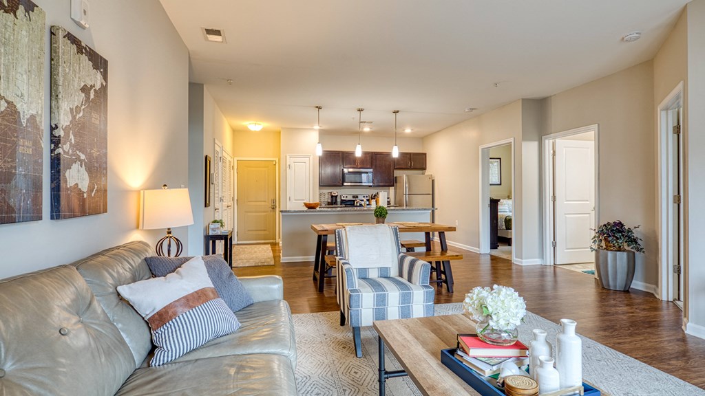a living room and kitchen with a couch and a table