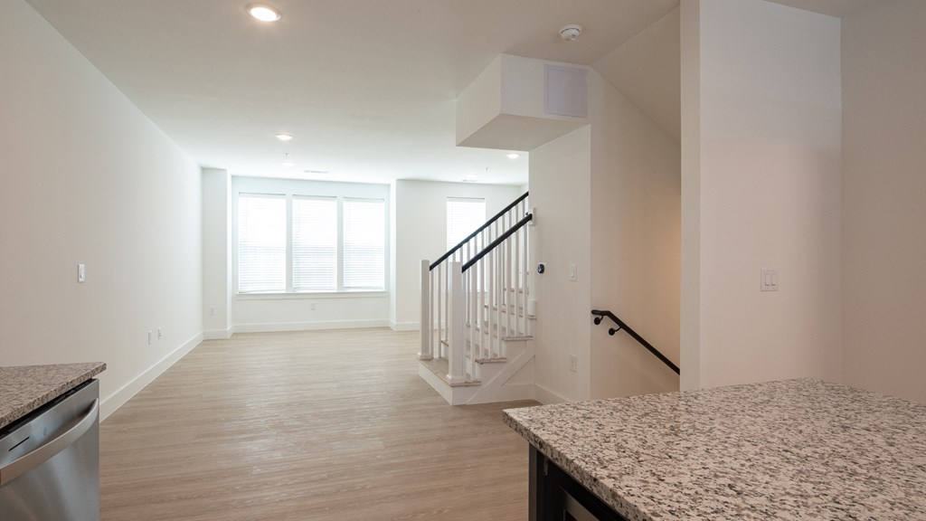 a kitchen and living room with white walls and wood floors at Ainsworth, Richmond, 23228