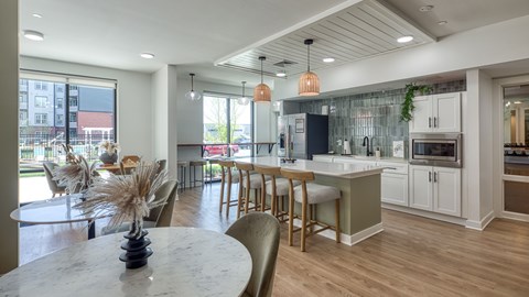 A modern kitchen with a dining table and chairs.
