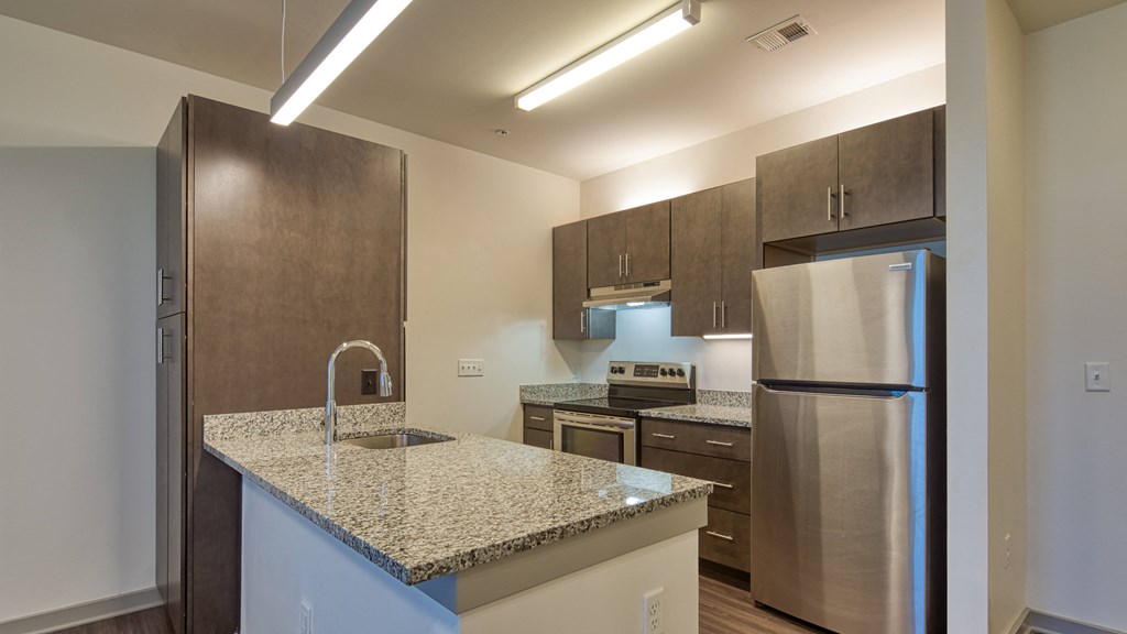 a kitchen with granite countertops and stainless steel appliances
