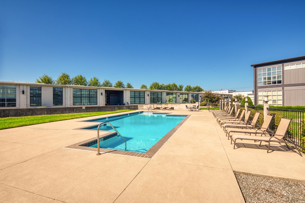 the preserve at ballantyne commons pool with chaise lounge chairs and a pool