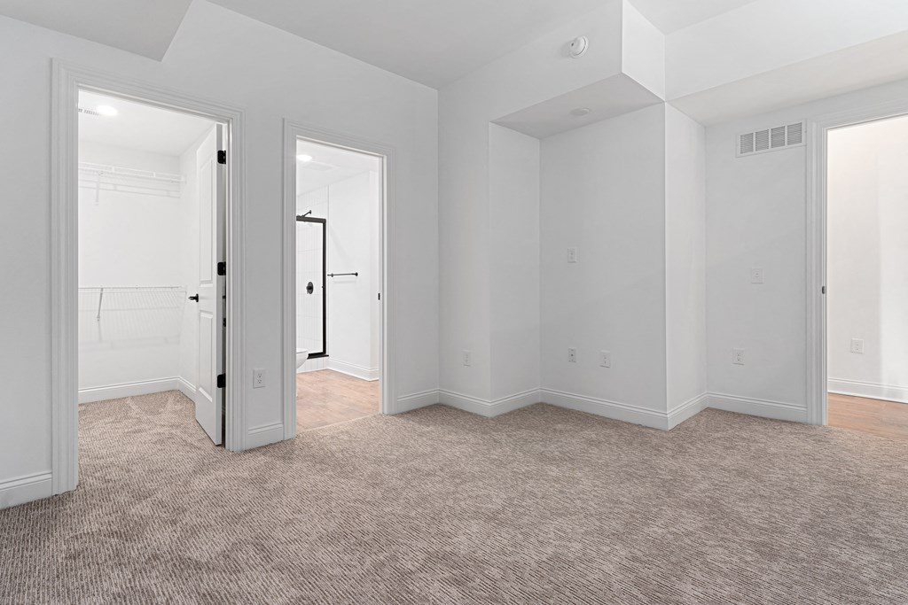 an empty living room with white walls and carpet at The Madison, Ohio, 43215