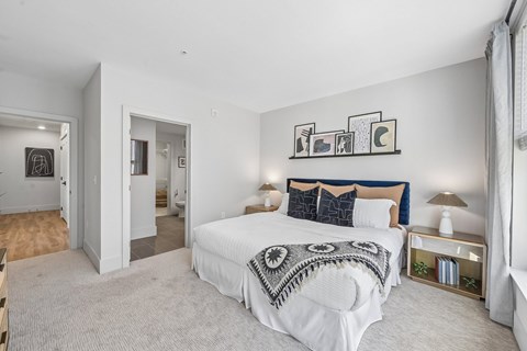 A bedroom with a large bed and a wall art.