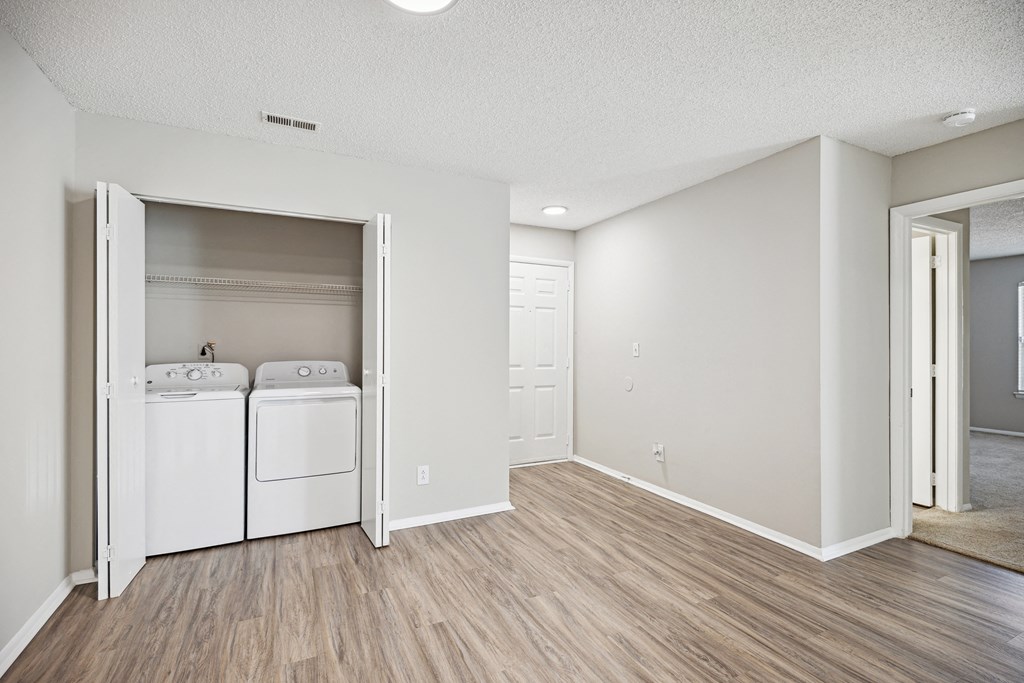 the spacious living room and laundry room with washer and dryer