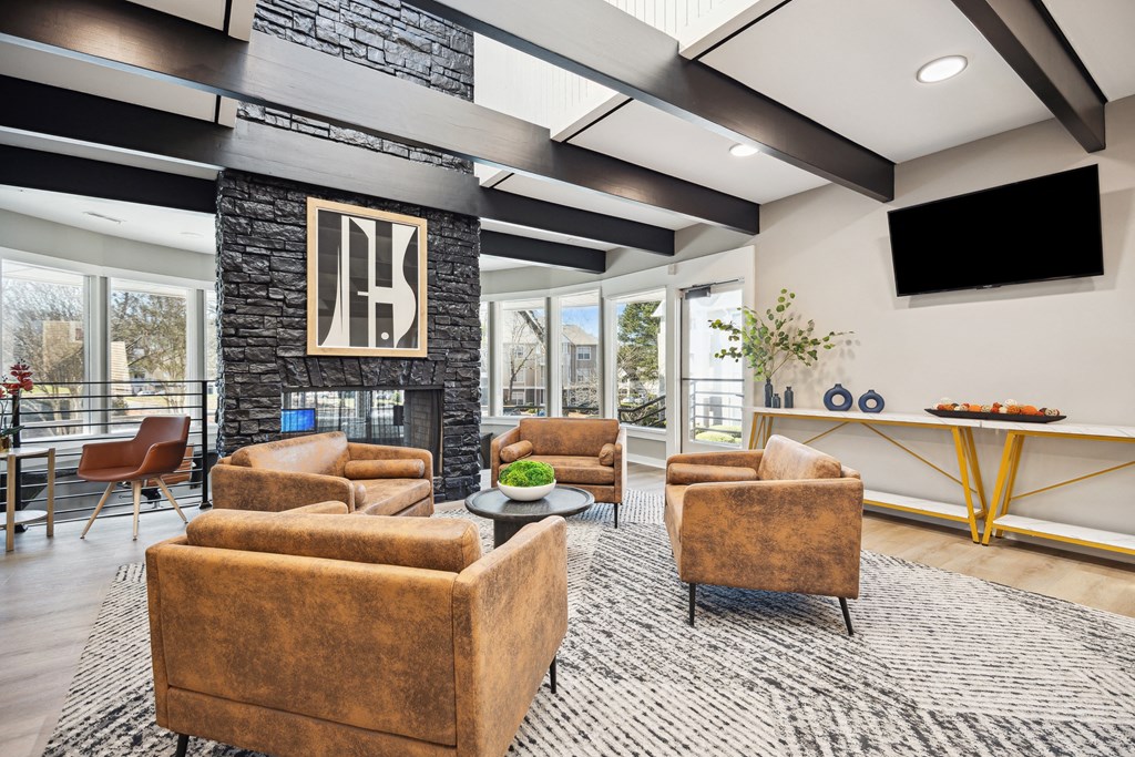 a living room with couches and chairs and a television