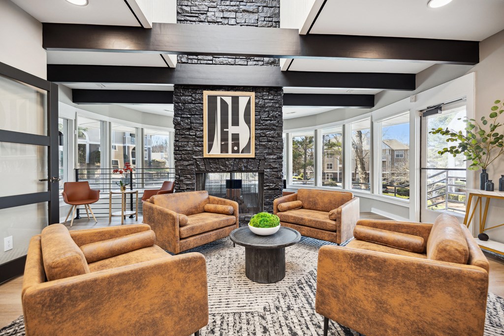 a living room with couches and chairs and a fireplace