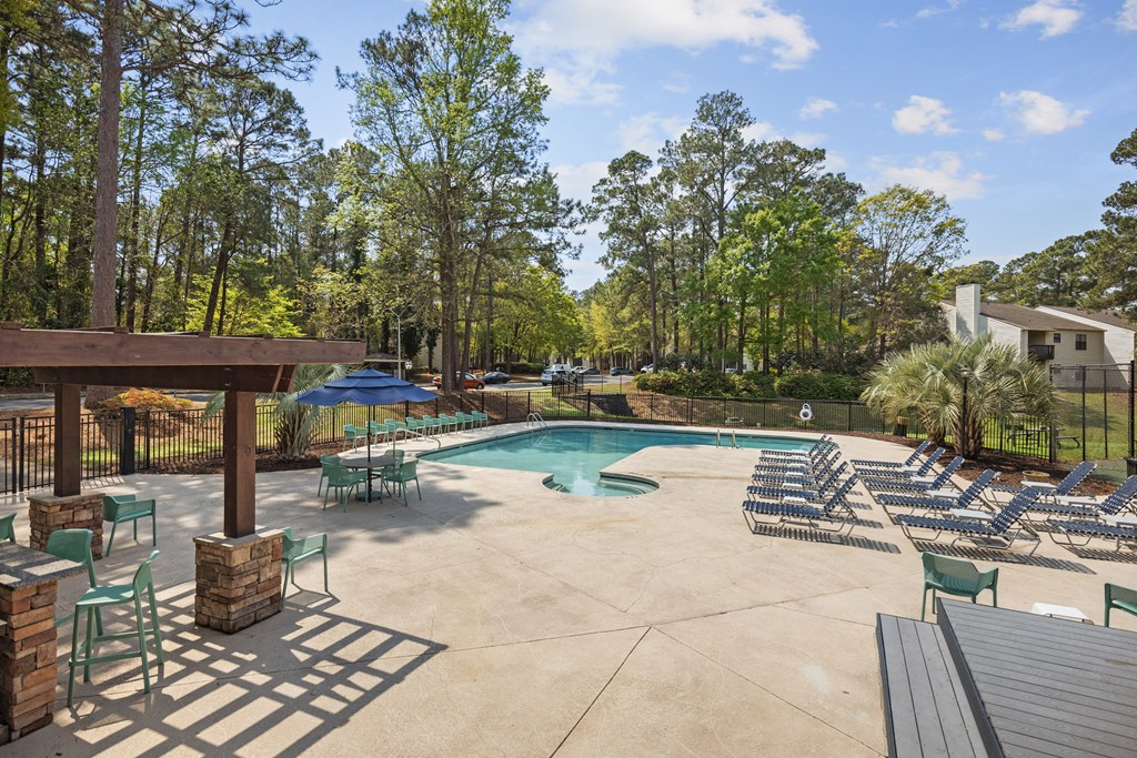 the resort style pool is surrounded by chairs and umbrellas