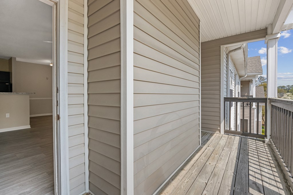 two photos of a porch with white wooden walls and a balcony