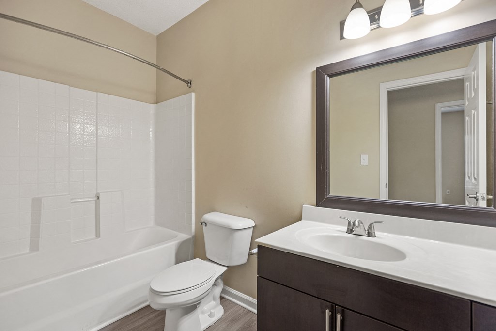 a bathroom with a sink toilet and a mirror