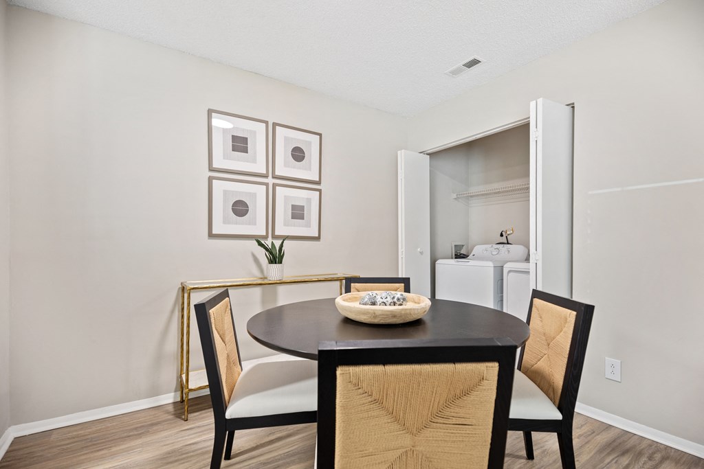 a dining room with a table and chairs and a living room