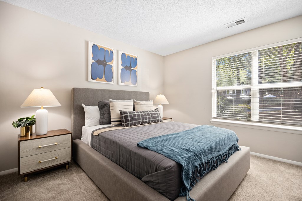 a bedroom with a bed and two windows