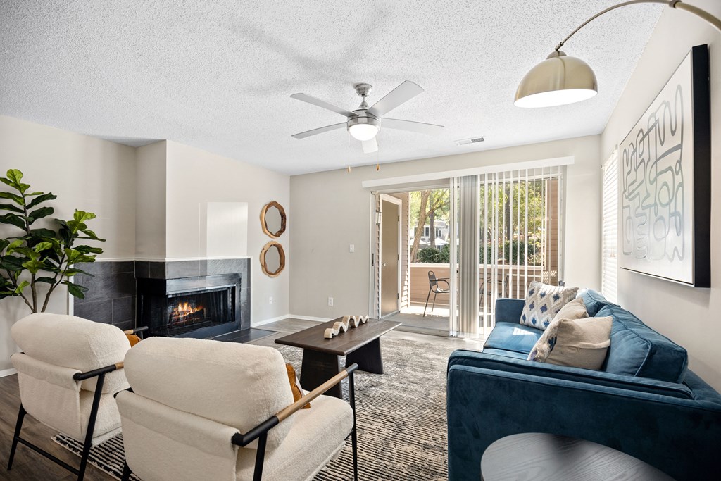 a living room with a couch and chairs and a fireplace