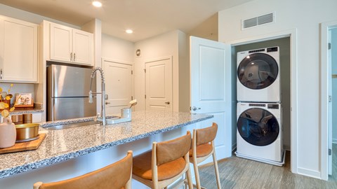 a kitchen with a counter top and a washer and dryer at Allure at Edinburgh, Virginia