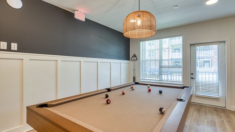 A pool table with balls set up in a rack.