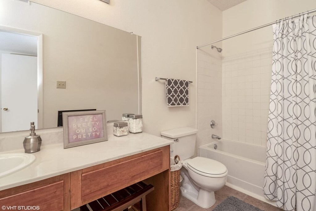 A bathroom with a toilet, sink, and shower.