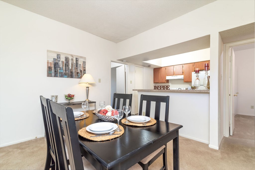 A dining room with a table set for two.