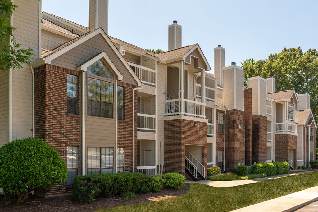 Apartment complex with brick and beige buildings.