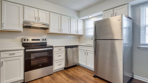 A kitchen with white cabinets and stainless steel appliances.