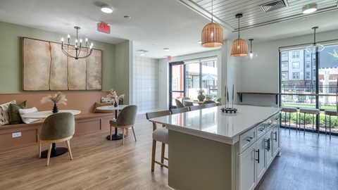 A modern kitchen with a dining area and a view of the city.