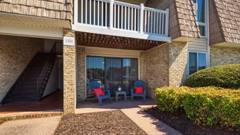 a patio with chairs outside of a building at Bayville Apartments in Virginia Beach, 23455
