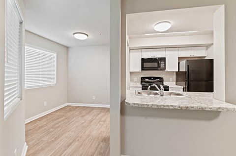 A kitchen with a microwave and oven on a counter.