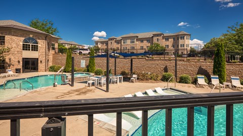 our apartments have a resort style pool with chairs and tables
