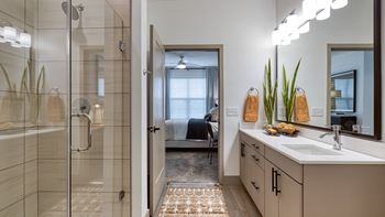a bathroom with a shower and a sink and a mirror at Aura Stonebridge, Richmond, Virginia