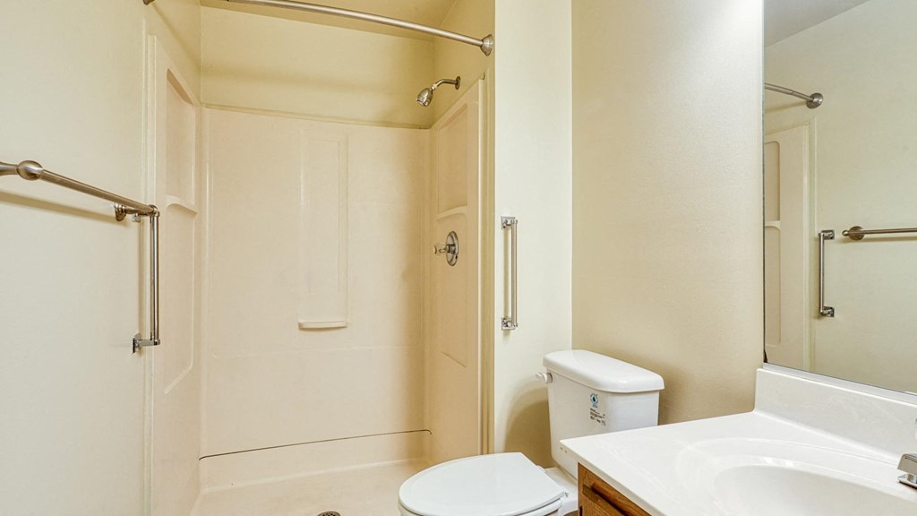 A white toilet sits next to a sink in a bathroom.