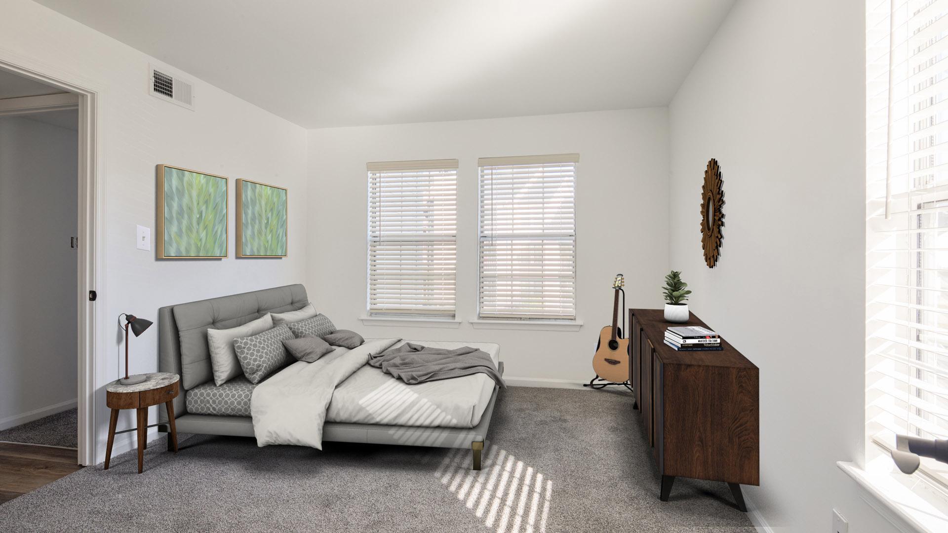 A bedroom with a bed, a nightstand, and a guitar.