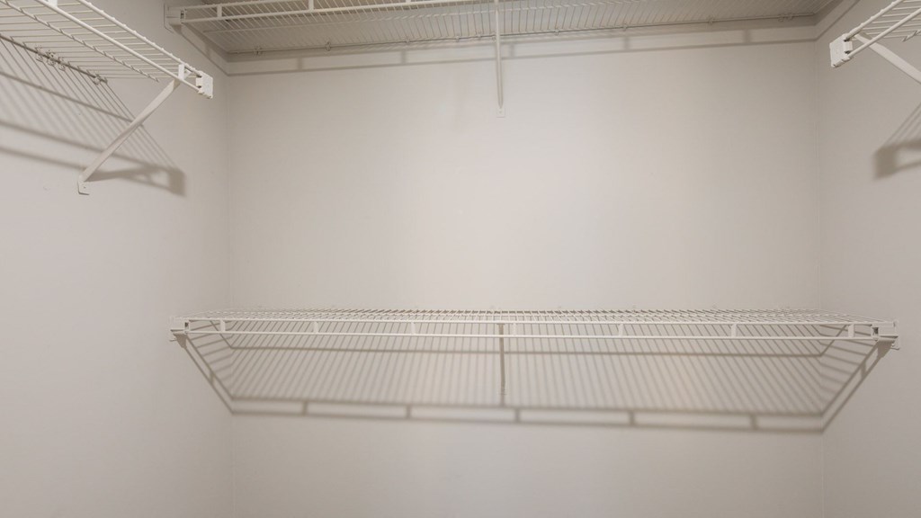 Empty white shelves in a room.