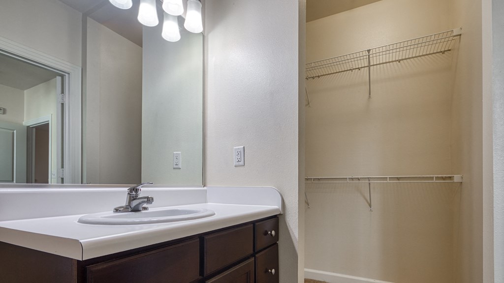 a bathroom with a sink and a mirror and a shower at Proximity at ODU, Norfolk