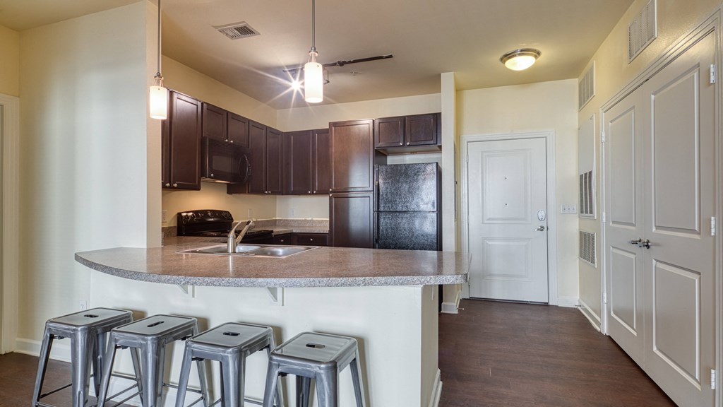 a kitchen with a counter top and bar stools at Proximity at ODU, Norfolk, VA, 23508