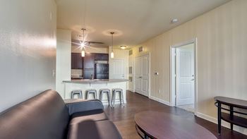 a living room and kitchen with a couch and a table