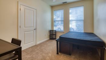 an empty room with a bed and a table