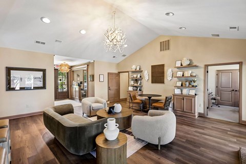 A living room with a grey couch and a wooden coffee table.
