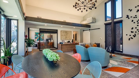 A modern dining room with a round table and chairs.