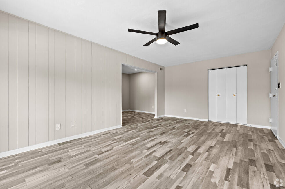 an empty living room with wood flooring and a ceiling fan at Bayville Apartments, Virginia Beach, 23455