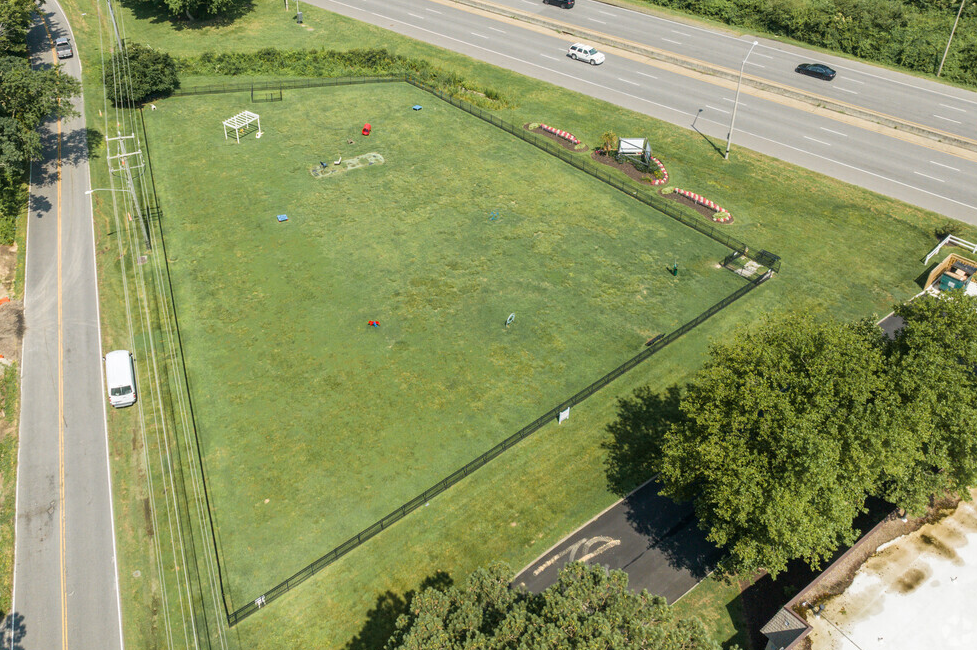 an aerial view of a green field next to a highway  at Bayville Apartments, Virginia