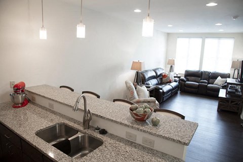 a kitchen with a sink and a living room with a couch