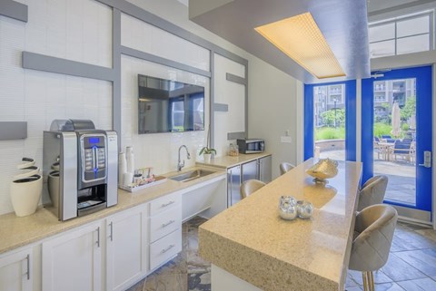 A kitchen with a table and chairs in front of a window.