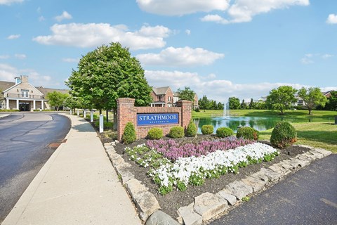 A sign that says Strathmoor in front of a building.