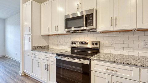 A kitchen with a stove and cabinets.